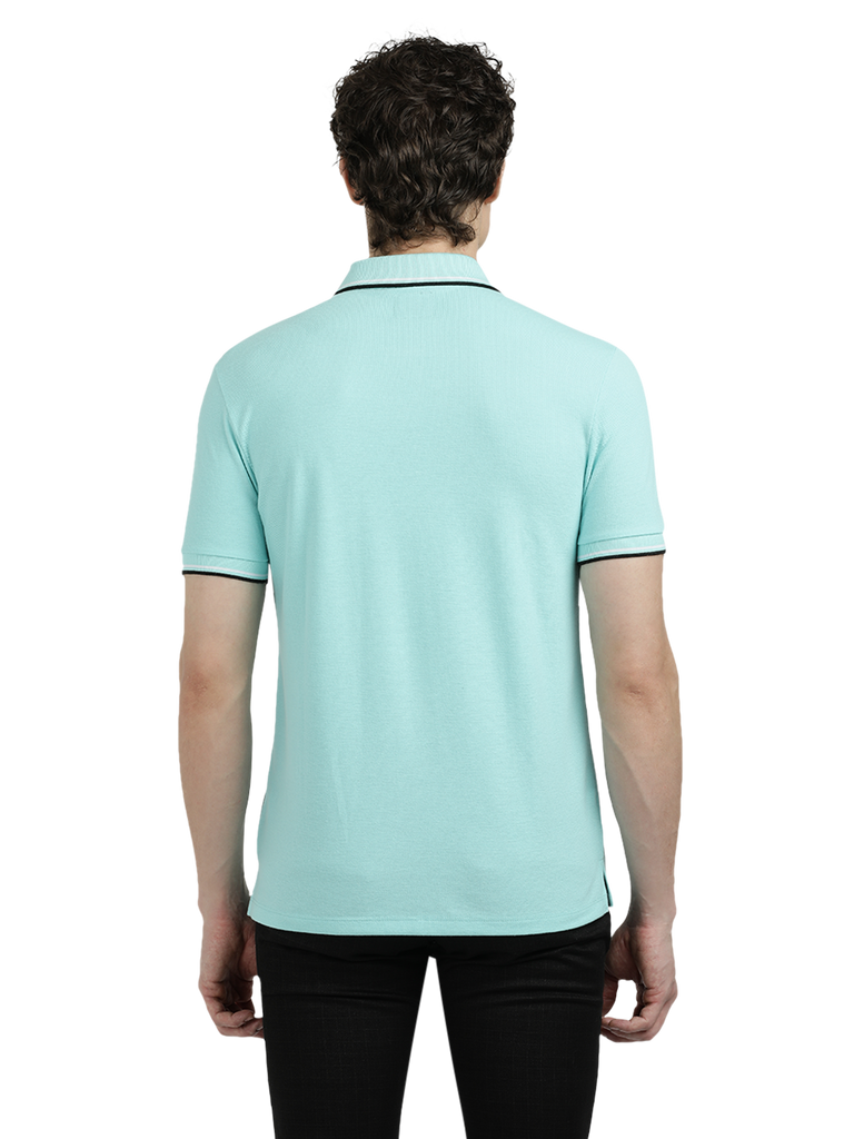 Model wearing Clarke Gable's Aqua Blue Solid Polo Collar T-Shirt in a casual setting