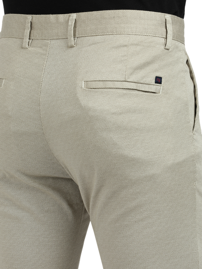 Model wearing Clarke Gable's Beige Custom Fit Trousers in a casual setting