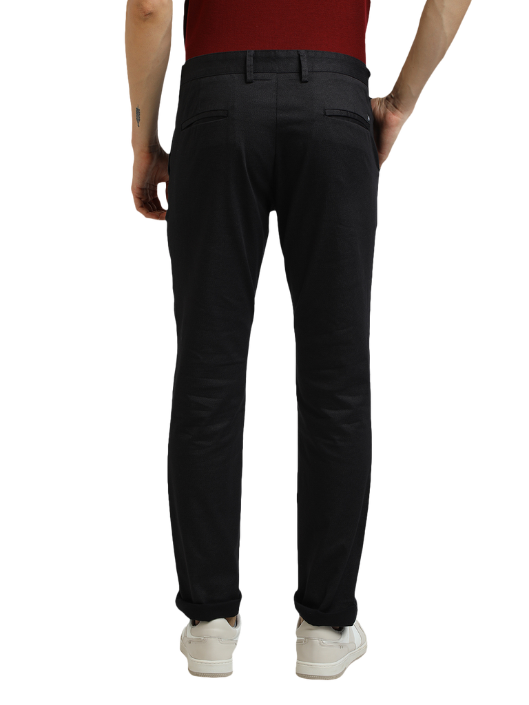 Model wearing Clarke Gable's Black Custom Fit Trousers in a casual setting