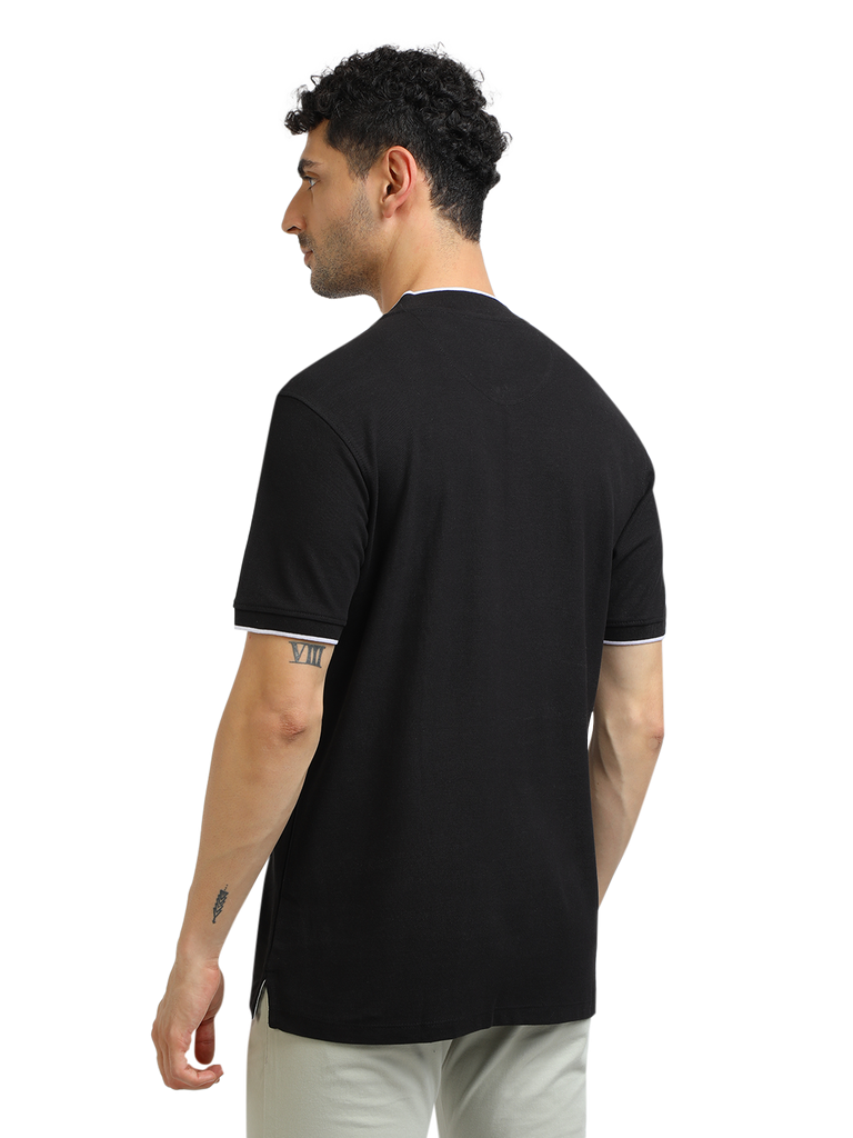 Model wearing Clarke Gable's Black Solid Henley Neck T-Shirt in a casual setting