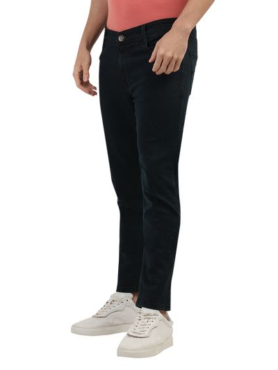 Model wearing Clarke Gable's Green Tinted Black Slim Fit Jeans in a casual setting