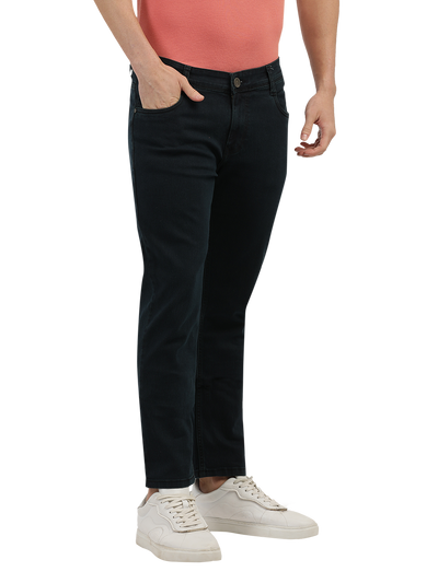 Model wearing Clarke Gable's Green Tinted Black Slim Fit Jeans in a casual setting