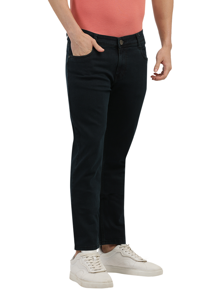 Model wearing Clarke Gable's Green Tinted Black Slim Fit Jeans in a casual setting