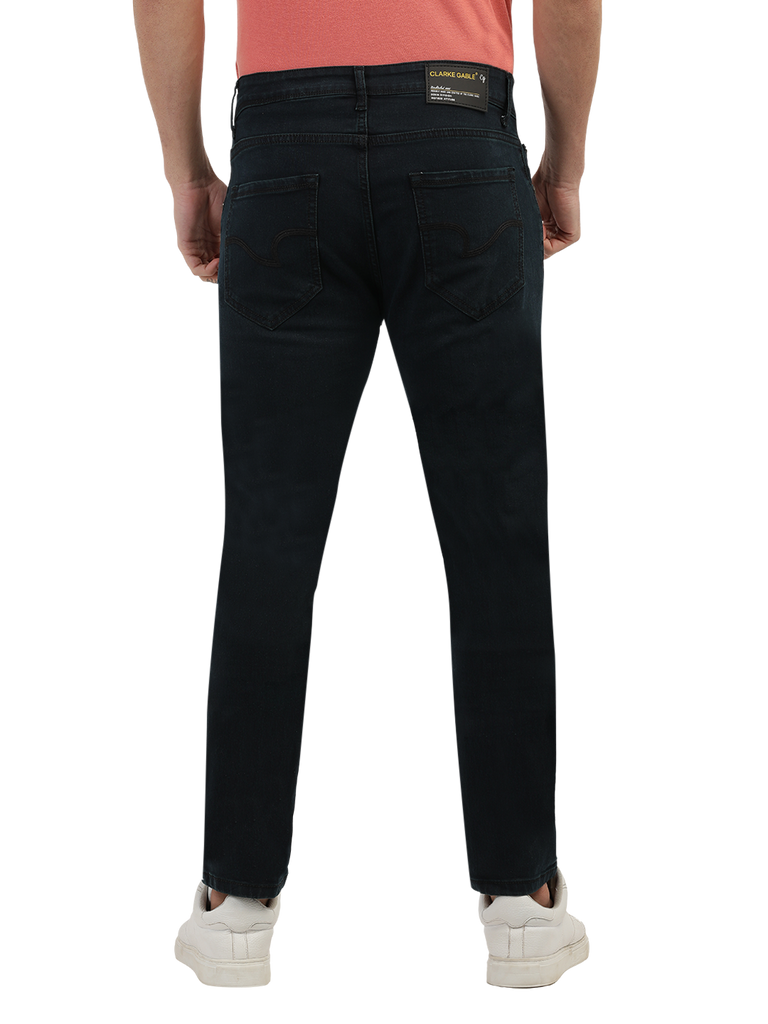 Model wearing Clarke Gable's Green Tinted Black Slim Fit Jeans in a casual setting