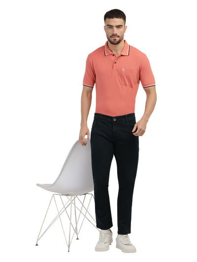 Model wearing Clarke Gable's Green Tinted Black Slim Fit Jeans in a casual setting