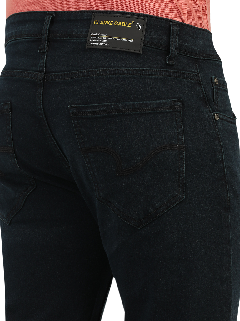 Model wearing Clarke Gable's Green Tinted Black Slim Fit Jeans in a casual setting