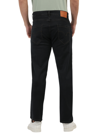 Model wearing Clarke Gable's Brown Tinted Smart Fit Jeans in a casual setting