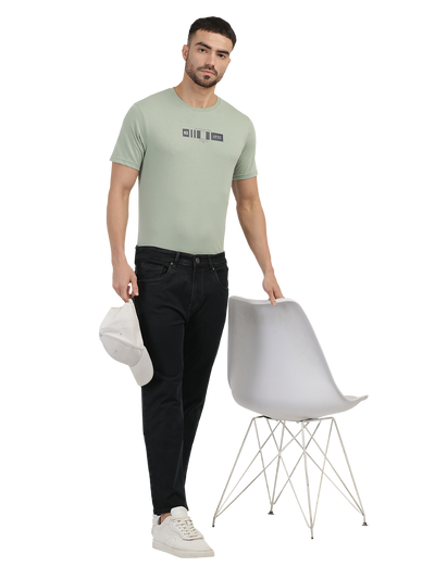 Model wearing Clarke Gable's Brown Tinted Smart Fit Jeans in a casual setting