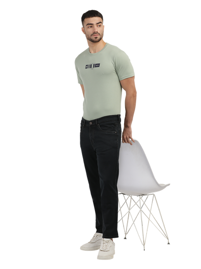 Model wearing Clarke Gable's Brown Tinted Smart Fit Jeans in a casual setting