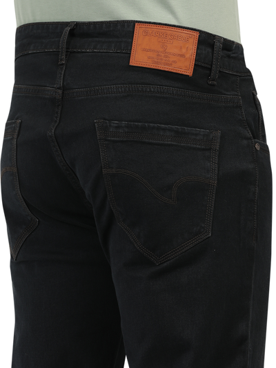 Model wearing Clarke Gable's Brown Tinted Smart Fit Jeans in a casual setting