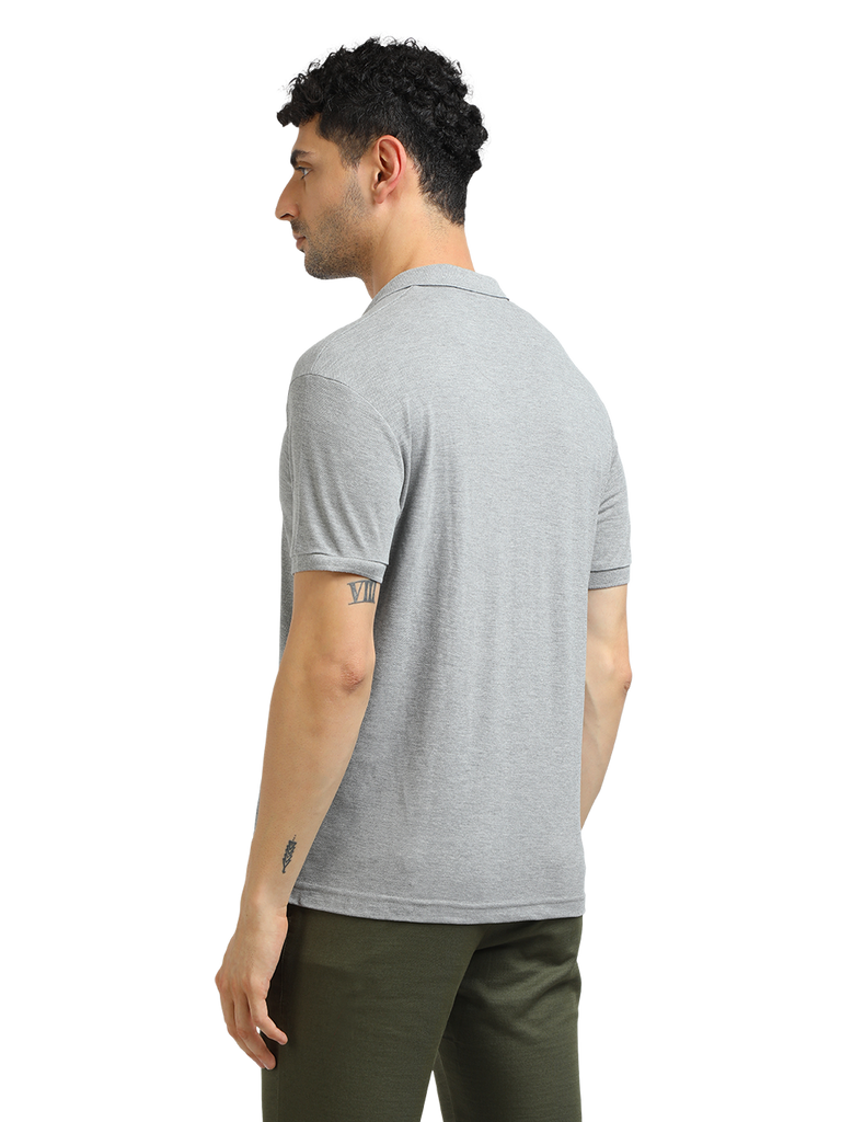 Model wearing Clarke Gable's Grey Melange Solid Polo Collar T-Shirt in a casual setting