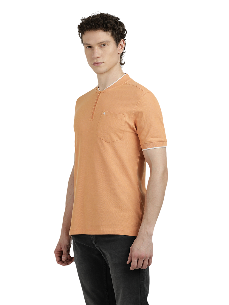 Model wearing Clarke Gable's Light Orange Solid Henley Neck T-Shirt in a casual setting