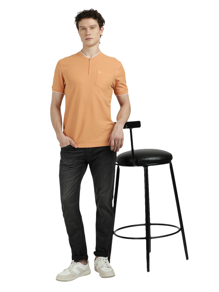 Model wearing Clarke Gable's Light Orange Solid Henley Neck T-Shirt in a casual setting