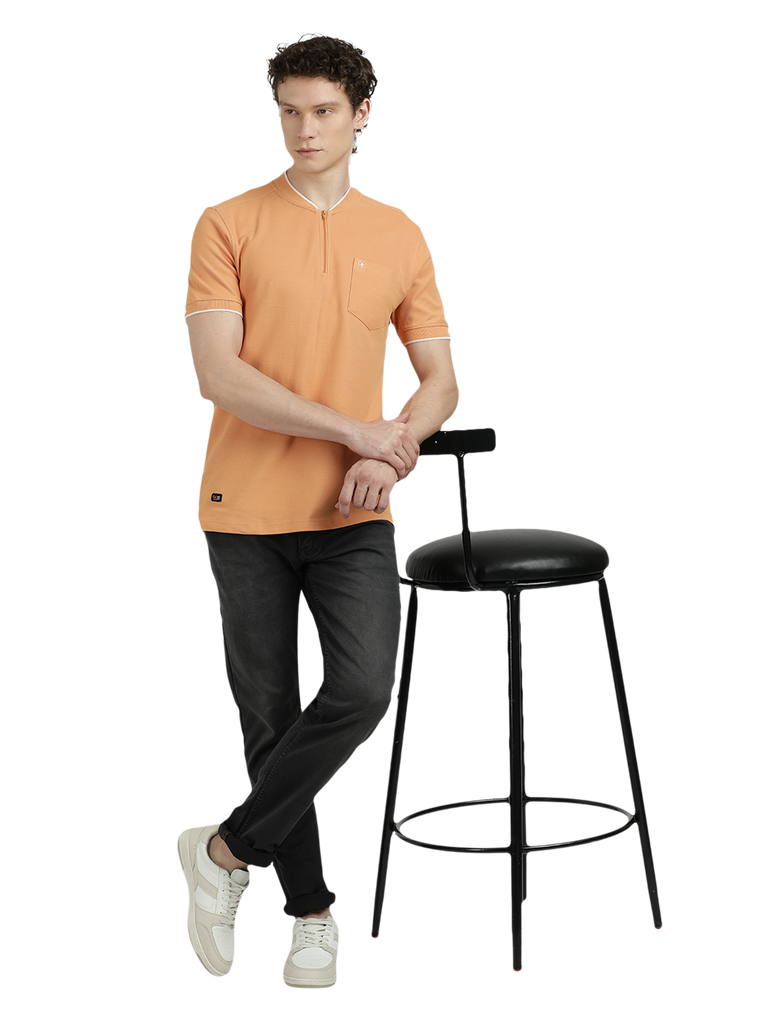 Model wearing Clarke Gable's Light Orange Solid Henley Neck T-Shirt in a casual setting