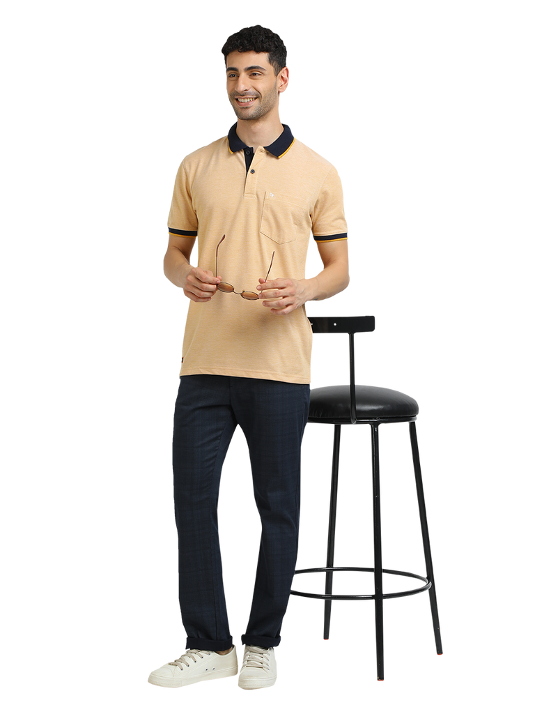 Model wearing Clarke Gable's Mustard Yellow Solid Polo Collar T-Shirt in a casual setting