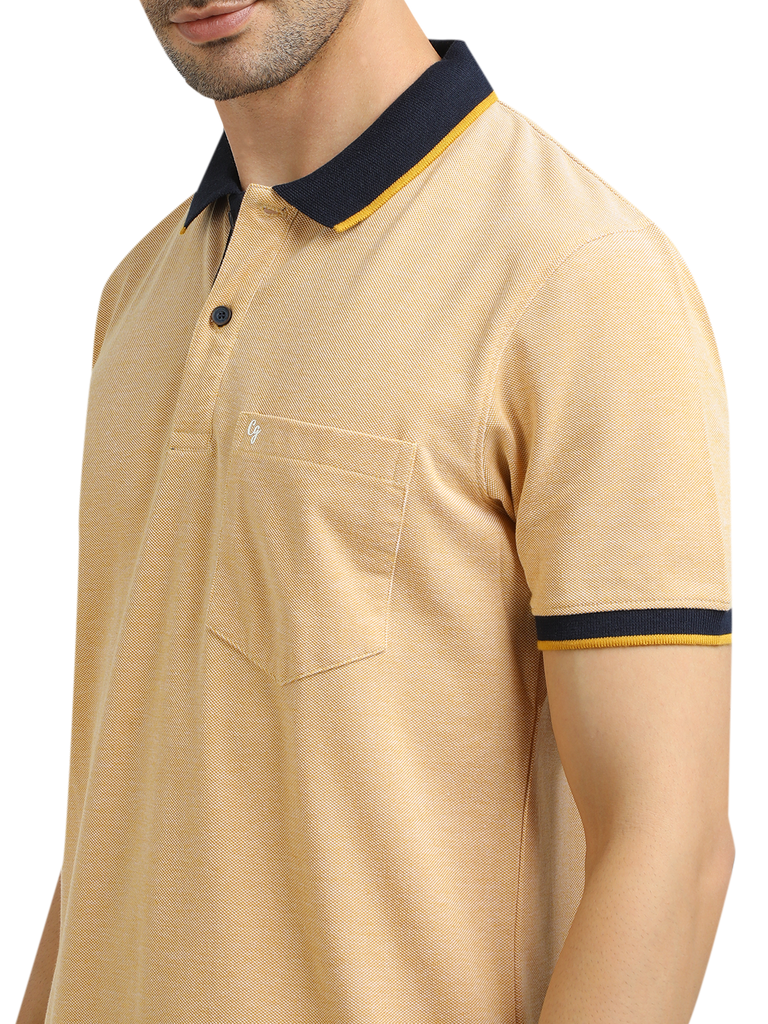 Model wearing Clarke Gable's Mustard Yellow Solid Polo Collar T-Shirt in a casual setting