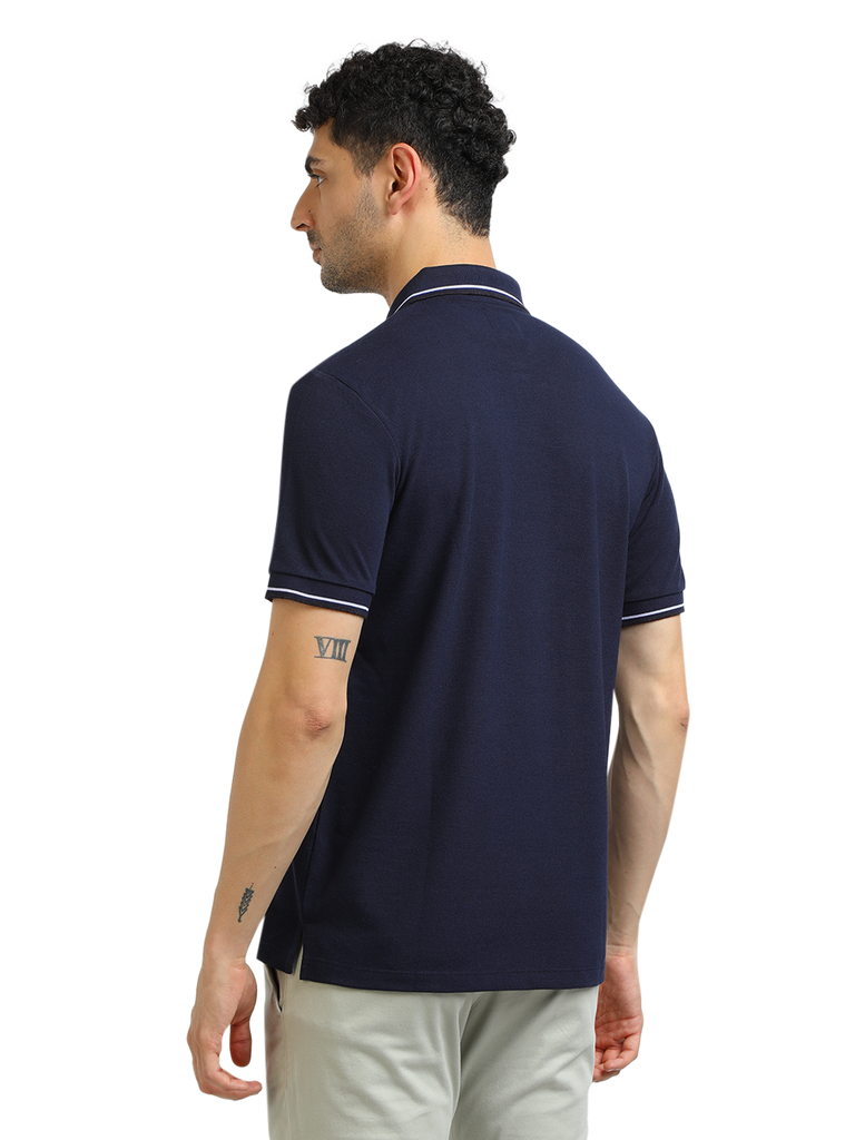 Model wearing Clarke Gable's Navy Blue Solid Polo Collar T-Shirt in a casual setting