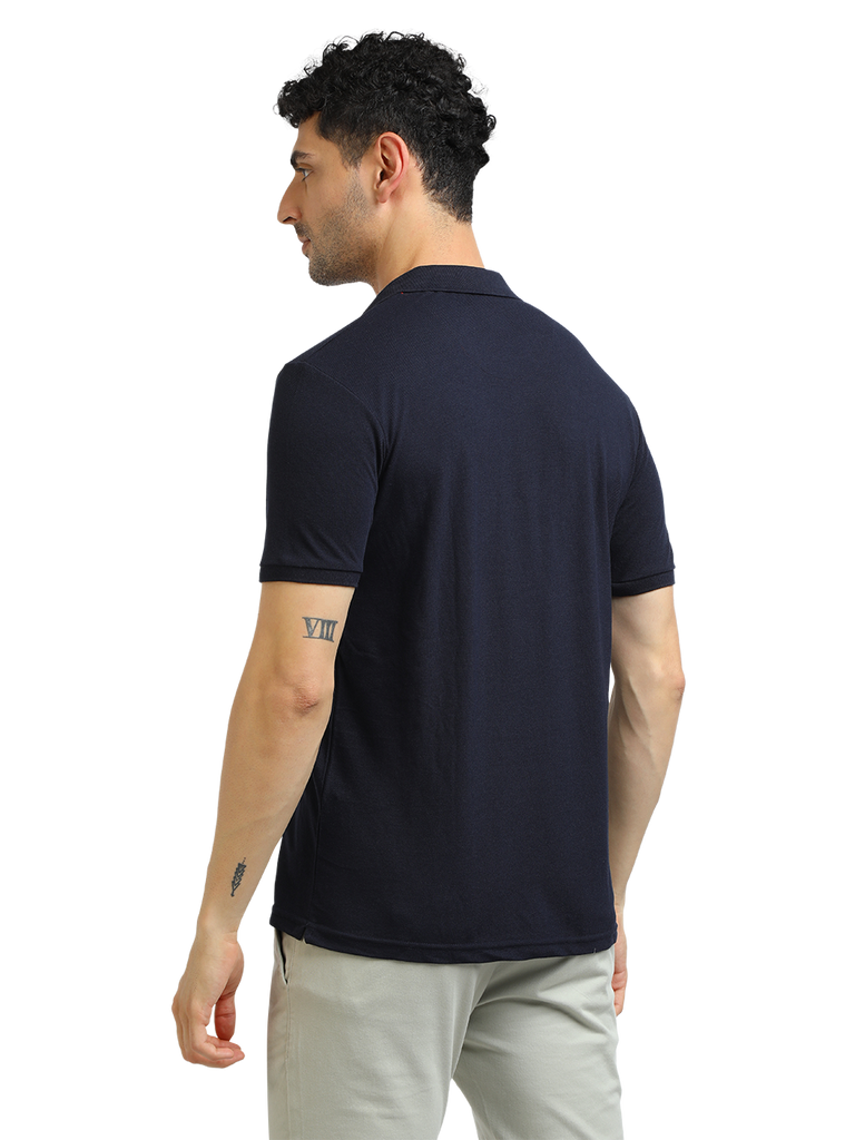 Model wearing Clarke Gable's Navy Solid Polo Collar T-Shirt in a casual setting