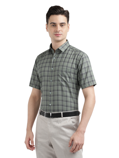 Model wearing Clarke Gable's Olive Green Checked Formal Shirt in a casual setting