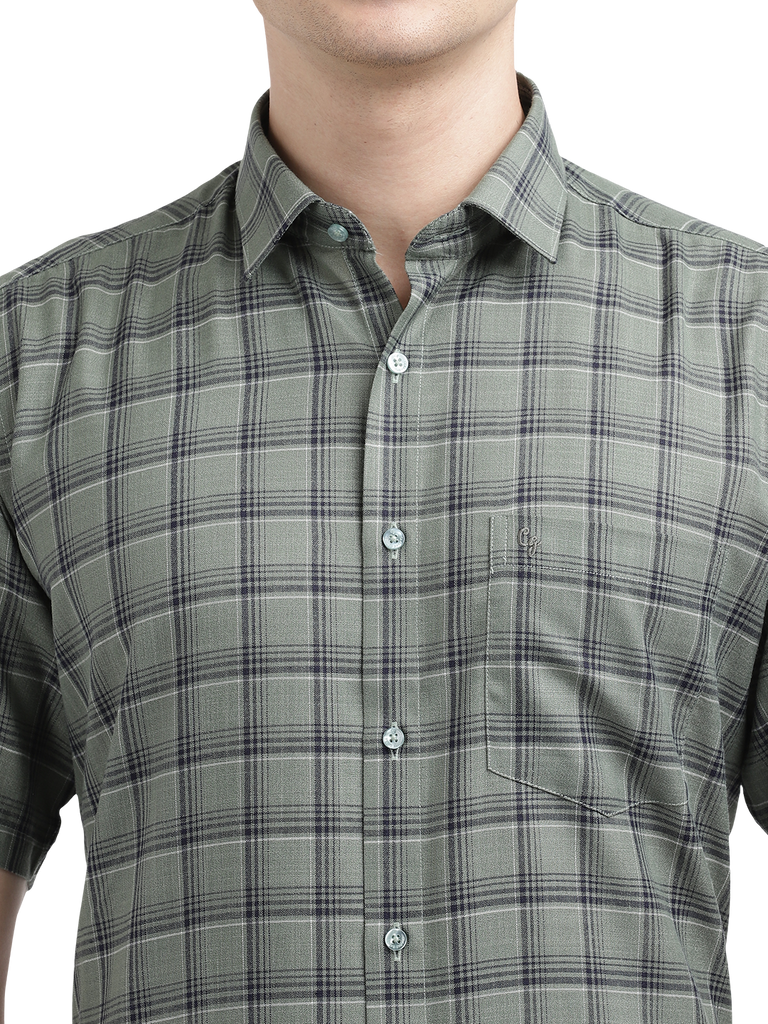 Model wearing Clarke Gable's Olive Green Checked Formal Shirt in a casual setting