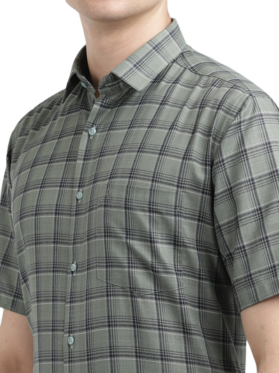 Model wearing Clarke Gable's Olive Green Checked Formal Shirt in a casual setting