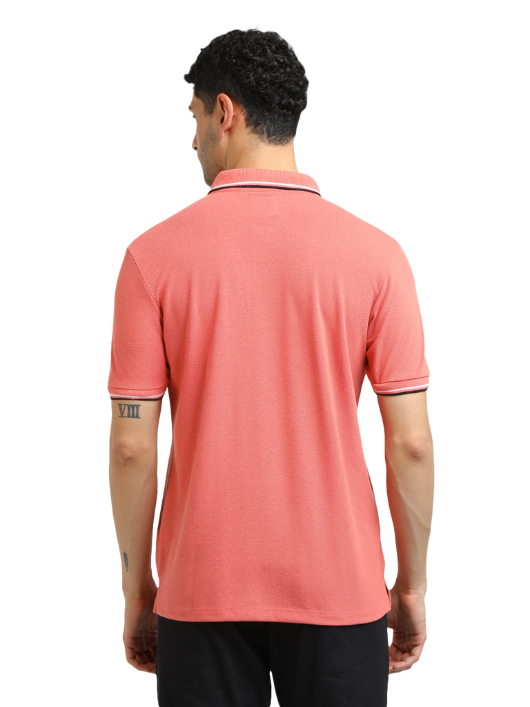 Model wearing Clarke Gable's Peach Solid Polo Collar T-Shirt in a casual setting