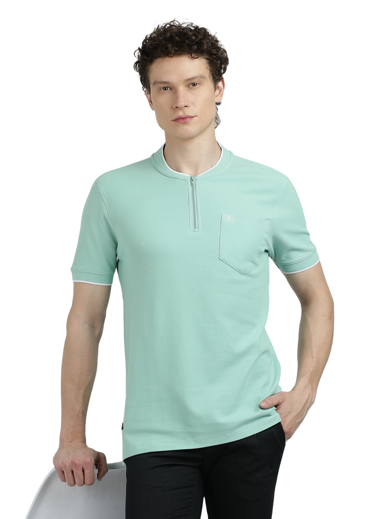 Model wearing Clarke Gable's Pista Green Solid Henley Neck T-Shirt in a casual setting