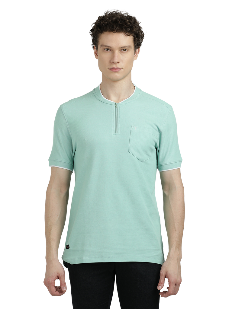 Model wearing Clarke Gable's Pista Green Solid Henley Neck T-Shirt in a casual setting