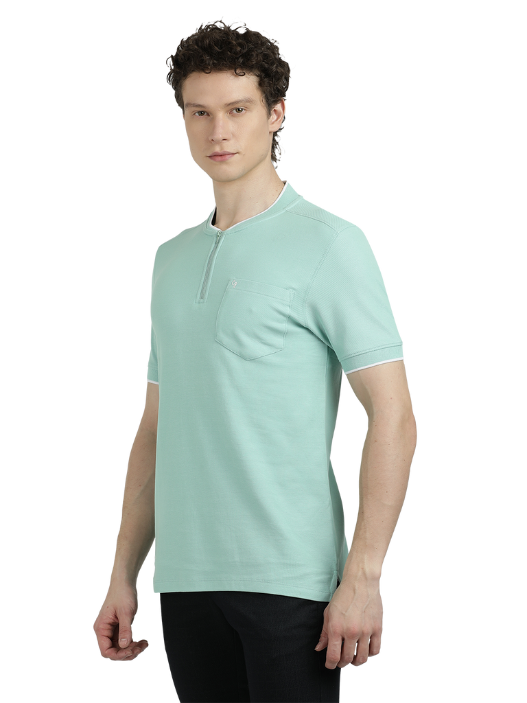 Model wearing Clarke Gable's Pista Green Solid Henley Neck T-Shirt in a casual setting