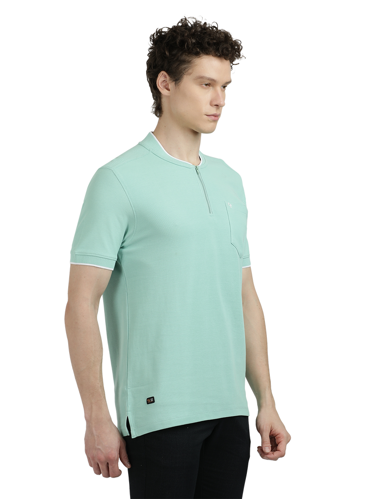 Model wearing Clarke Gable's Pista Green Solid Henley Neck T-Shirt in a casual setting