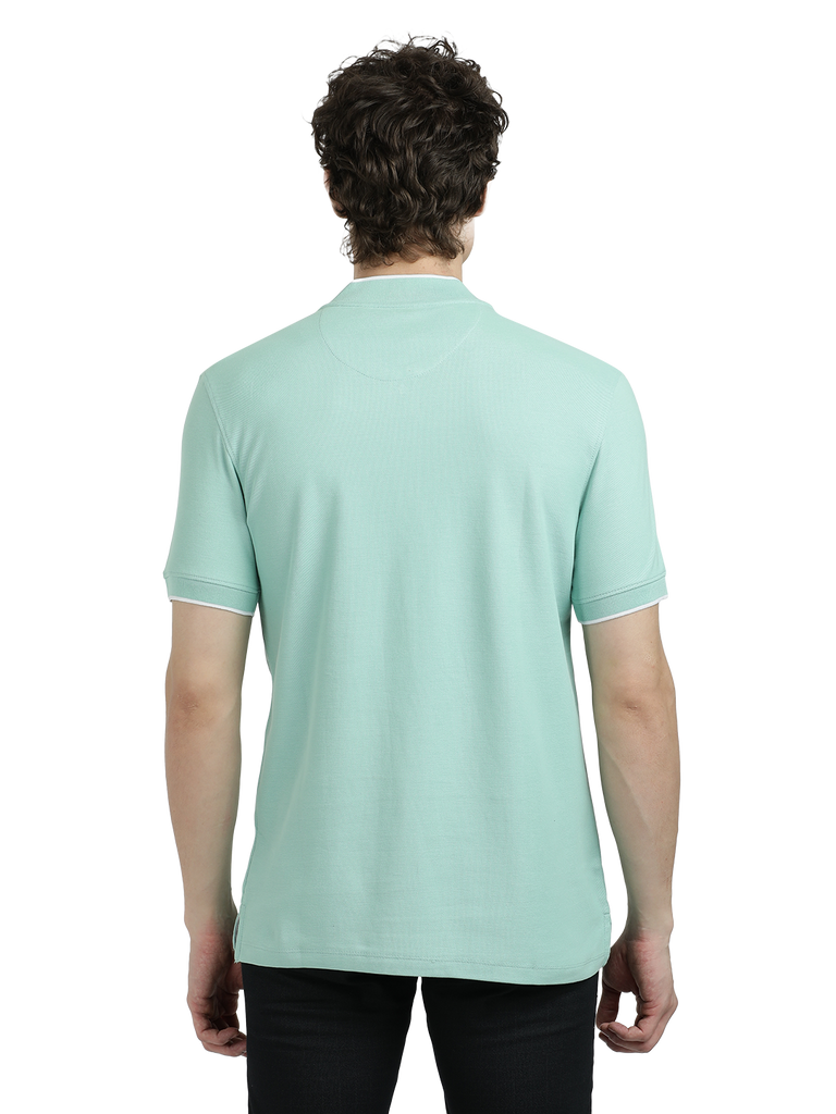 Model wearing Clarke Gable's Pista Green Solid Henley Neck T-Shirt in a casual setting