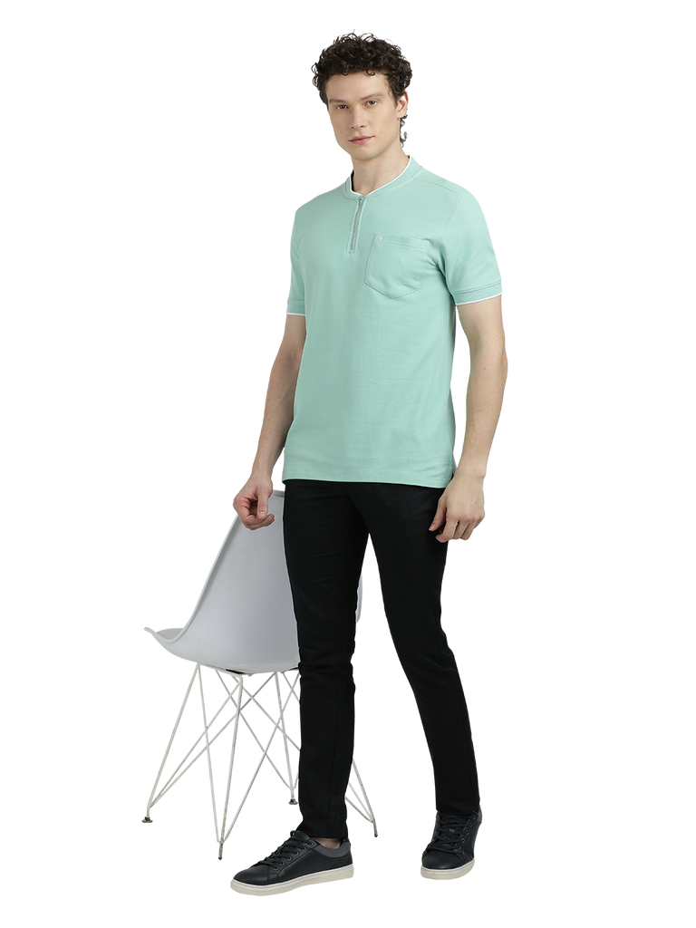 Model wearing Clarke Gable's Pista Green Solid Henley Neck T-Shirt in a casual setting