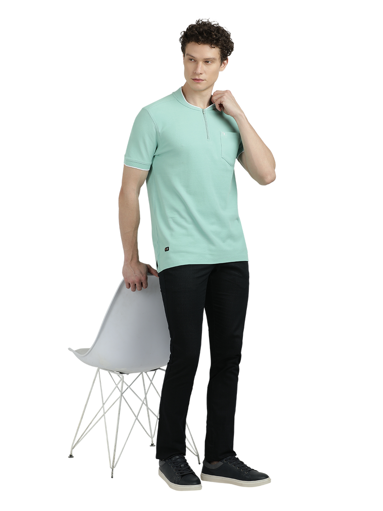 Model wearing Clarke Gable's Pista Green Solid Henley Neck T-Shirt in a casual setting