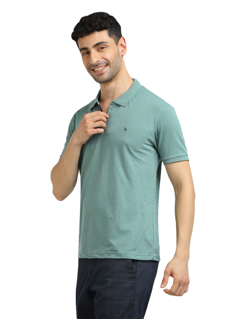 Model wearing Clarke Gable's Sea Green Solid Polo Collar T-Shirt in a casual setting