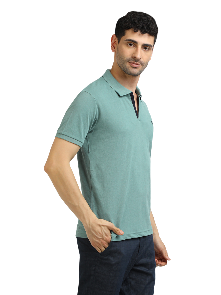 Model wearing Clarke Gable's Sea Green Solid Polo Collar T-Shirt in a casual setting