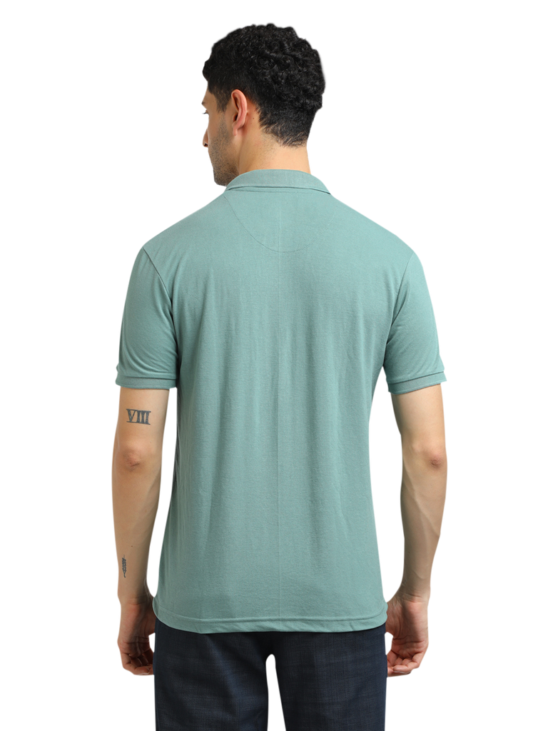 Model wearing Clarke Gable's Sea Green Solid Polo Collar T-Shirt in a casual setting