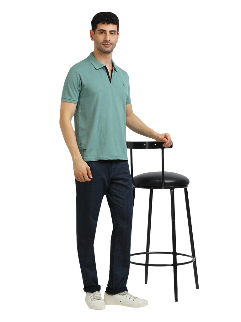 Model wearing Clarke Gable's Sea Green Solid Polo Collar T-Shirt in a casual setting