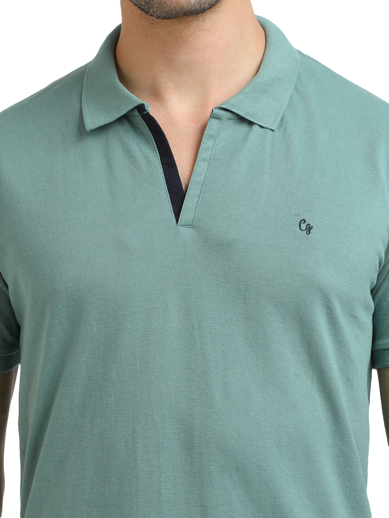 Model wearing Clarke Gable's Sea Green Solid Polo Collar T-Shirt in a casual setting