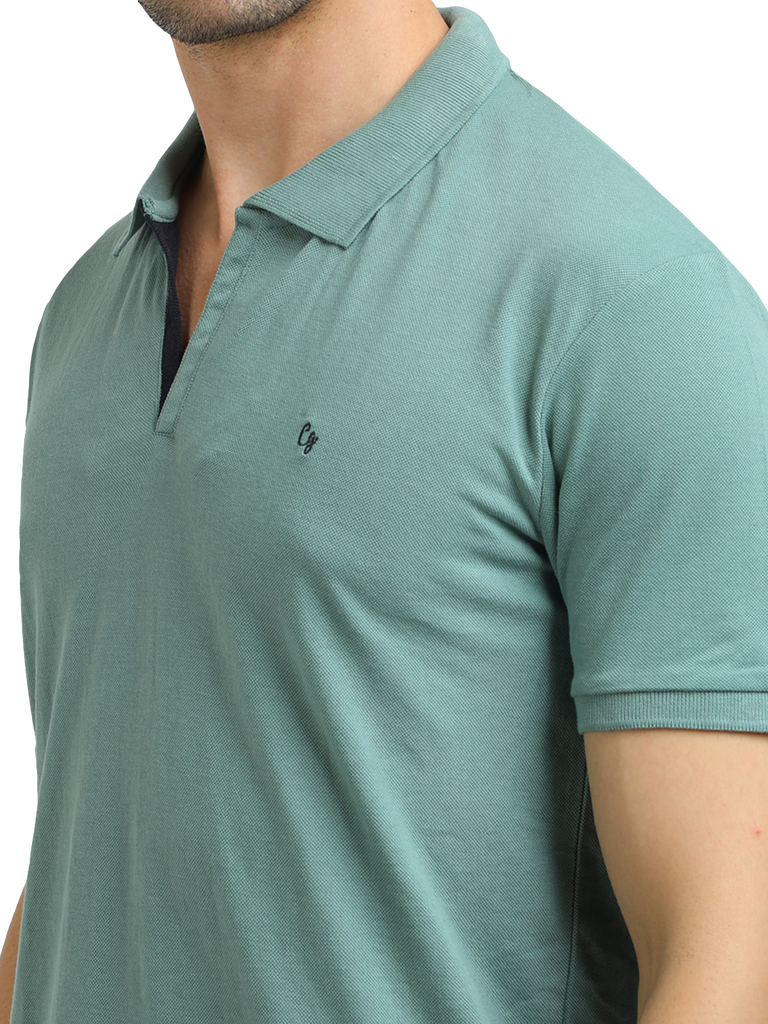 Model wearing Clarke Gable's Sea Green Solid Polo Collar T-Shirt in a casual setting