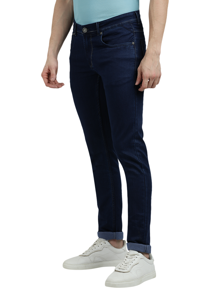 Model wearing Clarke Gable's Solid Dark Blue Skinny Fit Jeans in a casual setting