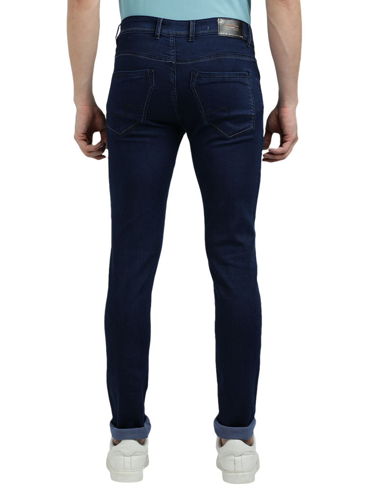 Model wearing Clarke Gable's Solid Dark Blue Skinny Fit Jeans in a casual setting