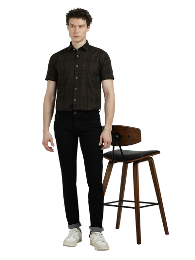 Model wearing Clarke Gable's Ultra Black Slim Fit Jeans in a casual setting